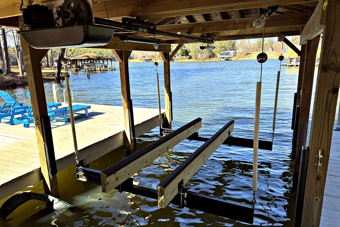 Timber boathouse with a boat lift over the water
